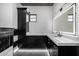 Modern bathroom with black and white marble tile, a large mirror, and stylish vanity at 1480 E Raven Ct, Gilbert, AZ 85297