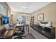 Bright home office with large desk and two chairs at 6782 W Firebird Dr, Glendale, AZ 85308