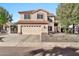 Two-story house with tan exterior, tile roof, and a two-car garage at 6782 W Firebird Dr, Glendale, AZ 85308