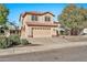 Two-story house with tan exterior, tile roof, and a two-car garage at 6782 W Firebird Dr, Glendale, AZ 85308