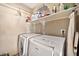 Laundry room with washer, dryer, and shelving at 6782 W Firebird Dr, Glendale, AZ 85308