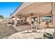 Spacious covered patio with dining and seating areas at 6782 W Firebird Dr, Glendale, AZ 85308