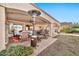 Covered patio with seating area, fire pit, and ceiling fan at 6782 W Firebird Dr, Glendale, AZ 85308