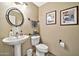 Stylish powder room with pedestal sink and toilet at 6782 W Firebird Dr, Glendale, AZ 85308