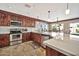 Modern kitchen with stainless steel appliances and an island at 6782 W Firebird Dr, Glendale, AZ 85308