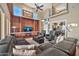 Spacious living room with high ceilings, a large sectional sofa, and a built-in entertainment center at 6782 W Firebird Dr, Glendale, AZ 85308
