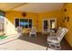 Covered patio with comfortable seating and tiled floor at 10637 W Welk Dr, Sun City, AZ 85373