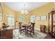 Bright dining room with wood table and chandelier at 10637 W Welk Dr, Sun City, AZ 85373