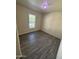 Third bedroom with wood-look floors and a window at 1304 E Bell Rd # 76, Phoenix, AZ 85022