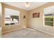 Well-lit bedroom with carpet flooring and large windows at 30302 N 130Th Gln, Peoria, AZ 85383