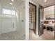 Modern bathroom with glass shower, white tile, and walk-in closet at 37200 N Cave Creek Rd # 1002, Scottsdale, AZ 85262