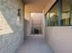 Covered walkway with stone wall and modern lighting at 37200 N Cave Creek Rd # 1002, Scottsdale, AZ 85262
