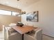 Modern dining room with wood table and statement art at 37200 N Cave Creek Rd # 1002, Scottsdale, AZ 85262