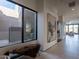 Bright entry hall with large window, tile flooring, and modern artwork at 37200 N Cave Creek Rd # 1002, Scottsdale, AZ 85262
