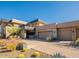 Modern home with three-car garage and desert landscaping at 37200 N Cave Creek Rd # 1002, Scottsdale, AZ 85262