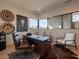 Spacious home office with wood desk, leather chair, and natural light at 37200 N Cave Creek Rd # 1002, Scottsdale, AZ 85262