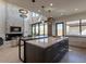 Open kitchen with expansive island, overlooks living room and fireplace at 37200 N Cave Creek Rd # 1002, Scottsdale, AZ 85262