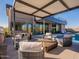 Modern patio furniture under a pergola, adjacent to the home at 37200 N Cave Creek Rd # 1002, Scottsdale, AZ 85262