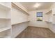 Large walk-in closet with built-in shelves and rods at 10331 E Starion Ave, Mesa, AZ 85212