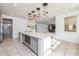 Island kitchen with white quartz countertops and gray cabinets at 9645 E Theia Dr, Mesa, AZ 85212