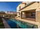 Inviting swimming pool with a large patio and surrounding landscape at 9645 E Theia Dr, Mesa, AZ 85212