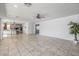 Open concept living room with kitchen view and tile floors at 9645 E Theia Dr, Mesa, AZ 85212