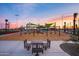 Playground with swings, slides, and shaded seating area at 9645 E Theia Dr, Mesa, AZ 85212