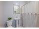 Simple bathroom with pedestal sink and striped shower curtain at 9645 E Theia Dr, Mesa, AZ 85212
