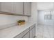 Kitchen features gray cabinets and white countertops at 9645 E Theia Dr, Mesa, AZ 85212