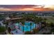 Community pool and recreation area with palm trees and sunset views at 9645 E Theia Dr, Mesa, AZ 85212