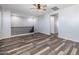 Spacious loft area with wood-look flooring and ceiling fan at 9645 E Theia Dr, Mesa, AZ 85212