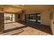 Covered patio with sliding glass doors, wood-like tile flooring, and a TV mount at 9645 E Theia Dr, Mesa, AZ 85212
