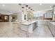 Open kitchen boasts an island, gray cabinets, and a brick accent wall at 9645 E Theia Dr, Mesa, AZ 85212