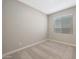 Simple bedroom with neutral walls and carpet, featuring a window with blinds at 10333 N 115Th Ave, Youngtown, AZ 85363