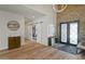 Grand entryway with barn door, stone accent wall, and hardwood floors at 27225 N 71St Pl, Scottsdale, AZ 85266