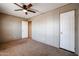 Well-lit bedroom with ceiling fan and carpet flooring at 10951 N 91St Ave # 6, Peoria, AZ 85345