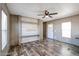 Living room with wood-look floors, ceiling fan, and built-in media console at 10951 N 91St Ave # 6, Peoria, AZ 85345