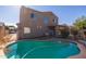 Inviting kidney-shaped pool with spacious patio and fenced backyard at 16170 W Port Royale Ln, Surprise, AZ 85379