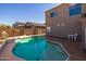 Relaxing pool area with patio furniture and lush landscaping at 16170 W Port Royale Ln, Surprise, AZ 85379