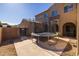 Backyard with patio, trampoline, and partial house view at 16170 W Port Royale Ln, Surprise, AZ 85379