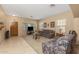 Spacious living room with tile and carpeted floors at 16170 W Port Royale Ln, Surprise, AZ 85379