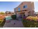 Landscaped backyard with covered patio and vibrant flowers at 16170 W Port Royale Ln, Surprise, AZ 85379