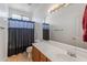 Bathroom with shower/tub combo, vanity, and linen closet at 16170 W Port Royale Ln, Surprise, AZ 85379