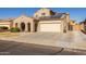 Two-story house with solar panels and a two-car garage at 16170 W Port Royale Ln, Surprise, AZ 85379