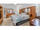 Main bedroom with large bed, dresser, and built-in wooden headboard at 16170 W Port Royale Ln, Surprise, AZ 85379