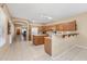 Kitchen with island, wood cabinets, and tile floor at 16170 W Port Royale Ln, Surprise, AZ 85379