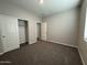 Bright bedroom with carpet flooring and a double-door closet at 7313 S 17Th Dr, Phoenix, AZ 85041