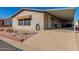 Single-wide manufactured home with covered patio and landscaping at 2400 E Baseline Ave # 201, Apache Junction, AZ 85119