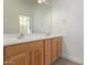 Bathroom with double vanity and light wood cabinets at 42424 N Gavilan Peak Pkwy # 53206, Anthem, AZ 85086