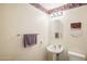 Clean bathroom with pedestal sink and updated fixtures at 16001 W Huron Dr, Sun City West, AZ 85375